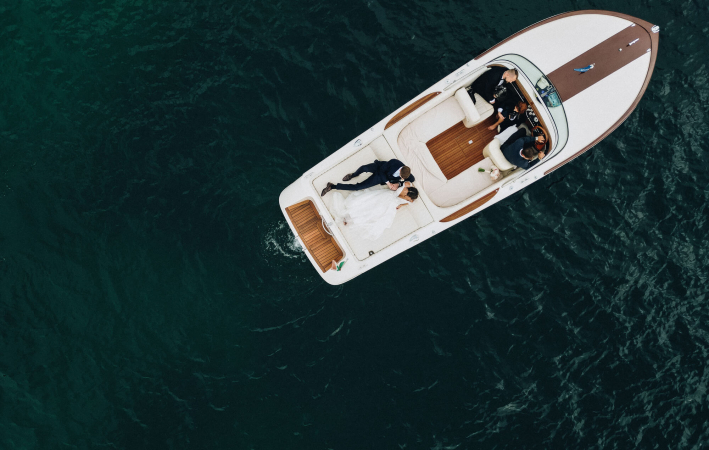 Couple on a boat at a luxury destination wedding at Isola del Garda, Lake Garda, Italy  