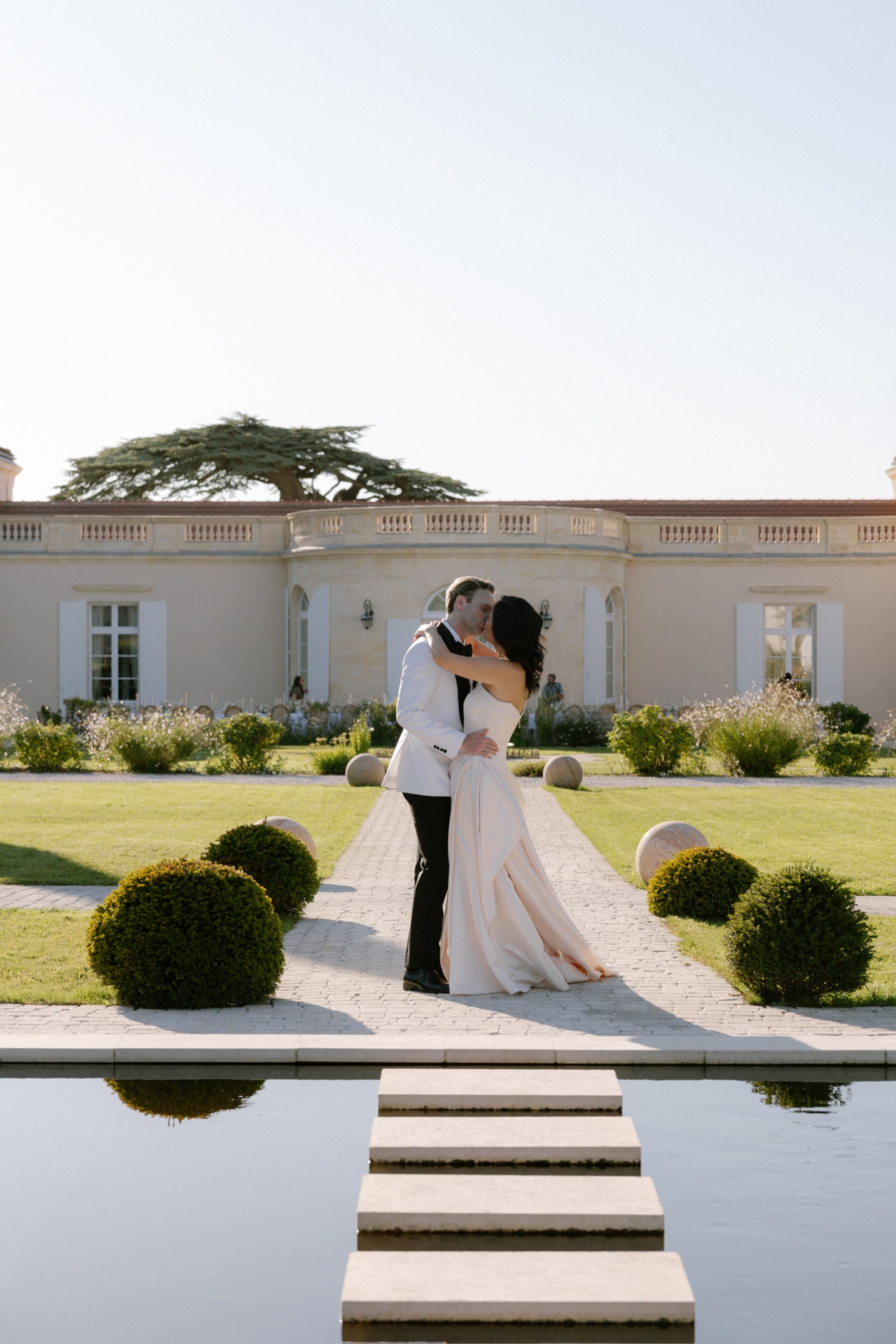 Bride and groom kissing at luxury destination wedding at Chateau Gassies, Bordeaux, France